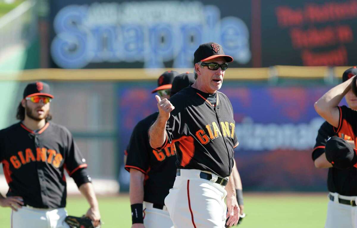 Bench coach Ron Wotus runs drills as the San Francisco Giants prepare to take on the Oakland Athletics in a spring training game at Scottsdale Stadium, in Scottsdale, Arizona on Wednesday Feb. 26, 2014.