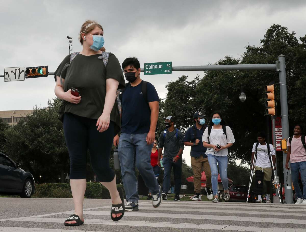 People cross Calhoun Road where it intersects University Drive on Tuesday, Aug. 31, 2021, on the University of Houston campus in Houston. Houston City Council will vote tomorrow to rename part of Calhoun Road to Martin Luther King Boulevard.