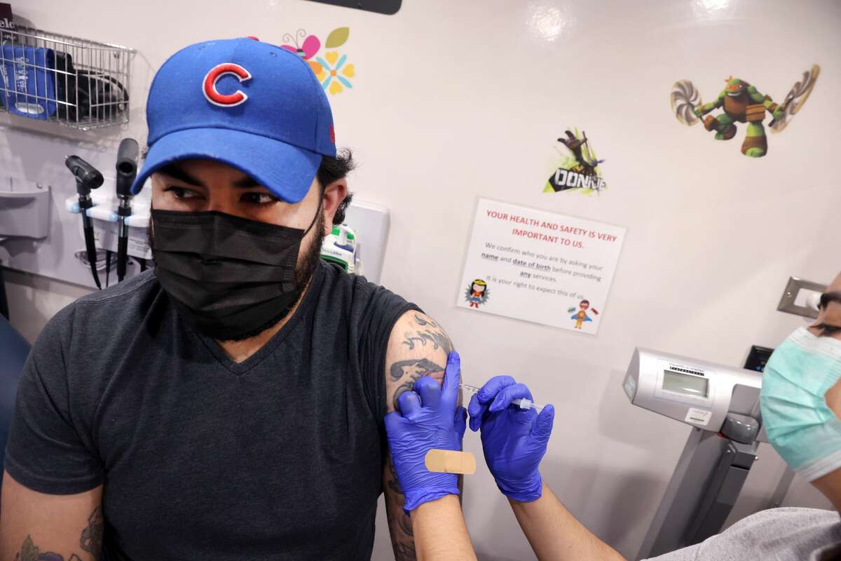 FILE - Abraham Arellano gets a COVID-19 vaccine at a mobile clinic being run by Humboldt Park Health on May 18, 2021 in Chicago, Illinois. (Photo by Scott Olson/Getty Images)