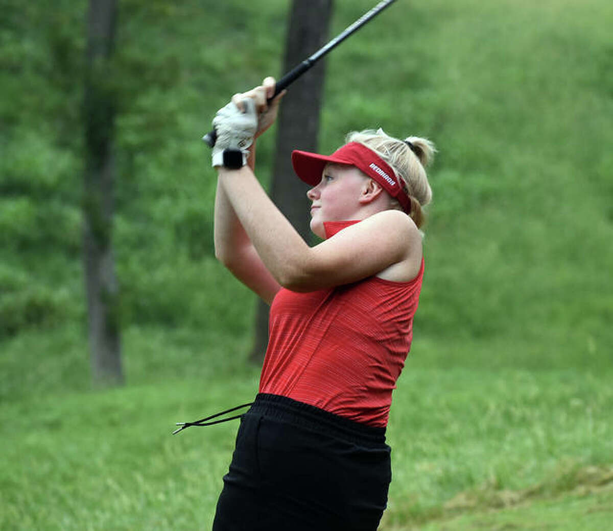 Alton’s Alexis Paulin watches her shot at Far Oaks Golf Club during the first round of the Southwestern Conference Tournament on Tuesday in Caseyville.