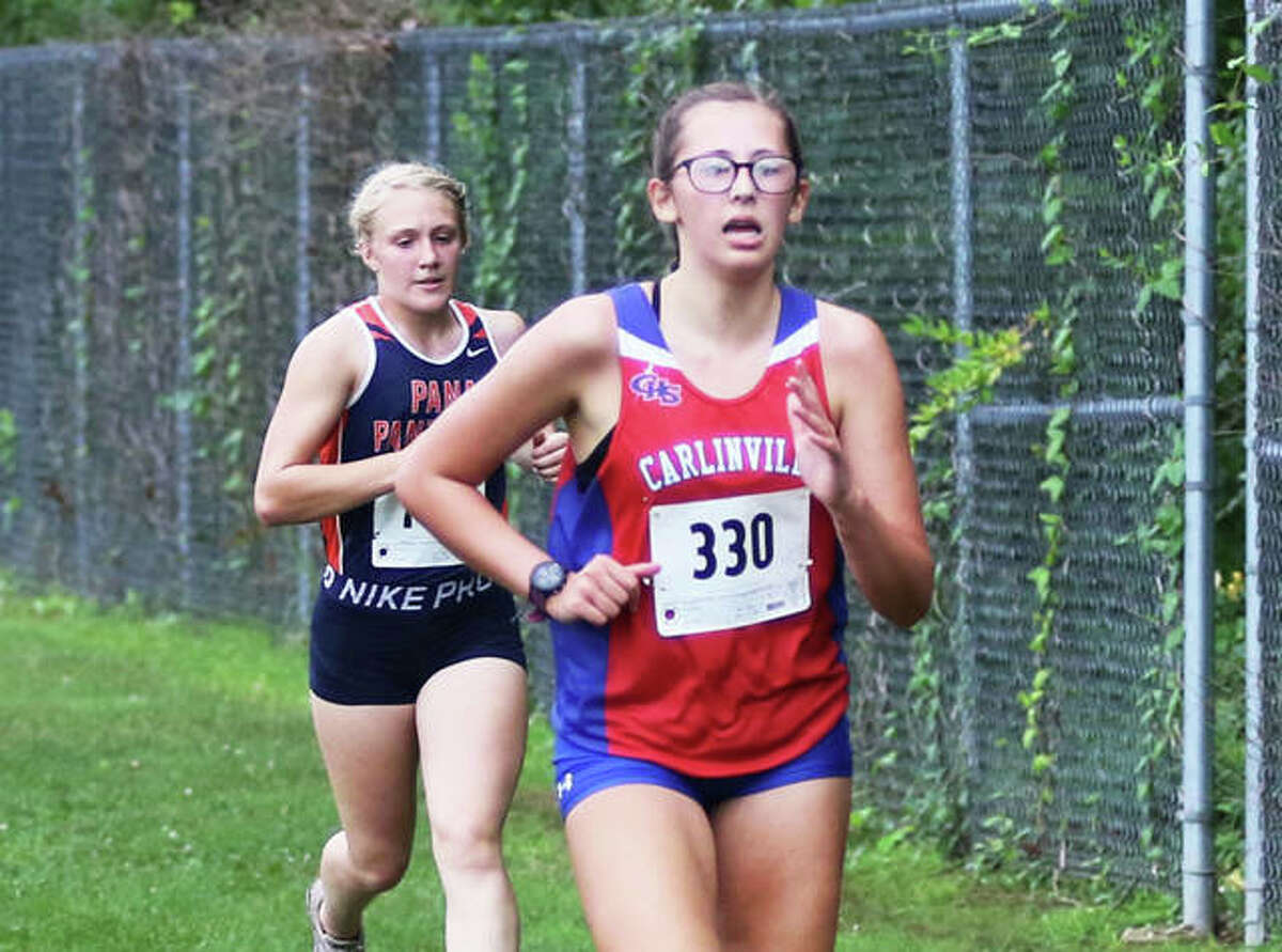 Carlinville’s Morgan Carrino (right), shown approaching the finish during the 2020 Carlinville Early Meet, was back at Loveless Park on Tuesday for the 2021 edition of the Early Meet in Carlinville. Carrino finished 10th in the girls race Tuesday.