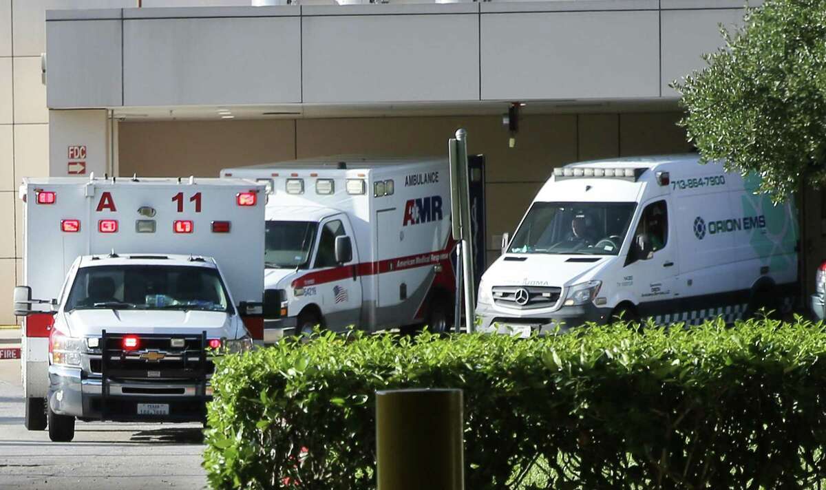 Ambulances line up outside the emergency entrance of Memorial Hermann Greater Heights Hospital in Houston on Friday, Aug. 20, 2021.