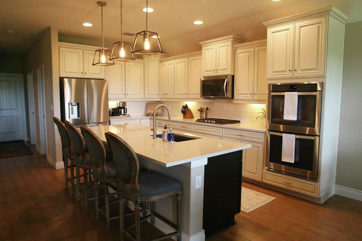 While they kept the cream-colored kitchen cabinets, the Granatos replaced the countertops and backsplash.