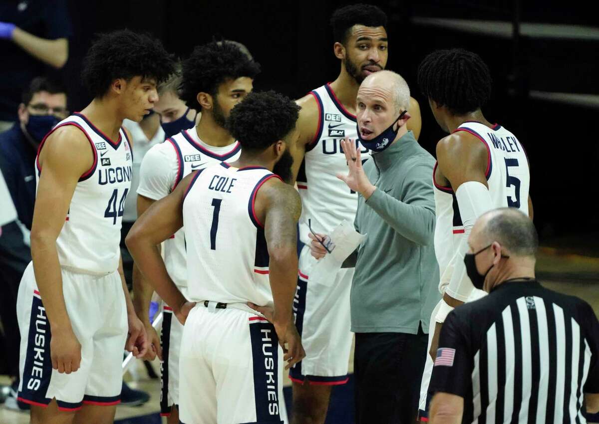 Connecticut head coach Dan Hurley talks to his team during a break in the action against Seton Hall during the first half of an NCAA college basketball game, Saturday, Feb. 6, 2021, at Harry A. Gampel Pavilion in Storrs, Conn. (David Butler II/Pool Photo via AP)