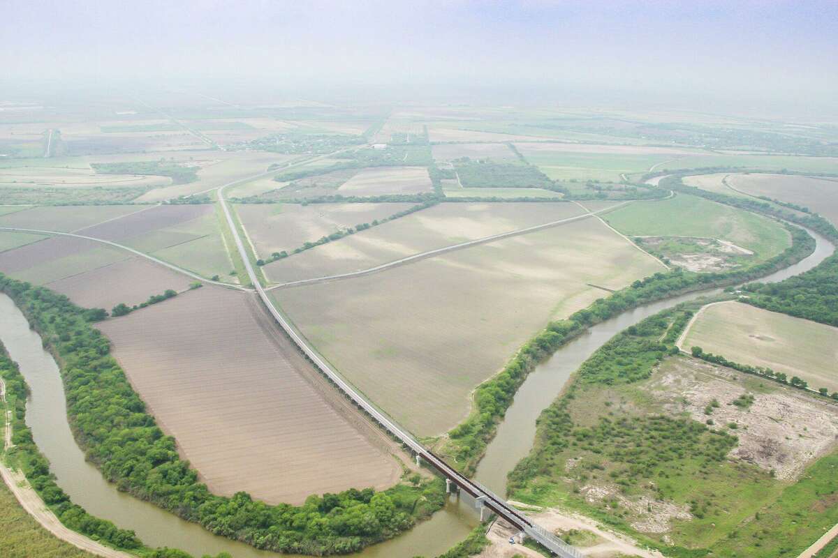 An aerial view shows the West Rail Bridge as it crosses the Rio Grande and into Mexico from the United States. The rail relocation project spanned 15 years and cost more than $120 million. It is the first U.S.-Mexico rail bridge in 100 years. Though international rail makse up a small part of goods that pass across the U.S. border with Mexico, regional business leaders say the bridge is key to the long-term success of the region.