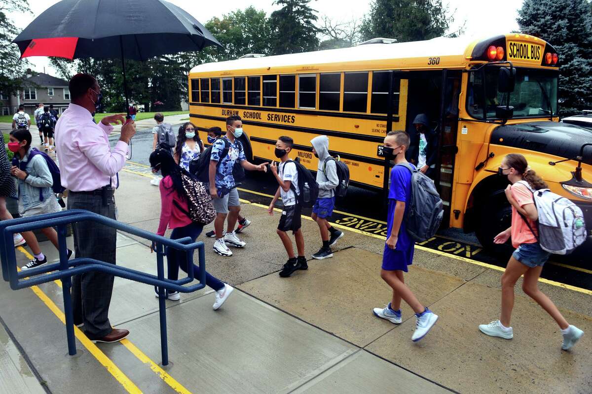 Principal Steve Gottlieb greets students as they arrive for the first day of class at Harborside Middle School, in Milford, Conn. Sept. 1, 2021.