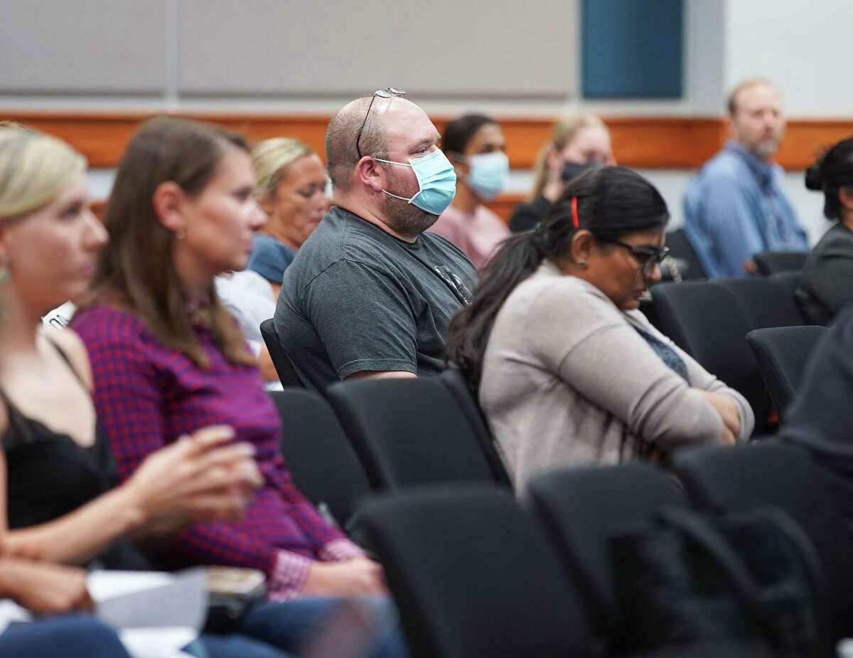 Attendees, mostly unmasked, listen to speakers at a Katy ISD Board of Trustees meeting about COVID protocols on Monday, Aug. 30, 2021. Some parents and students asked the board to change course and mandate masks to slow the spread of the virus. The approved COVID mitigation measures do not include mask requirements.
