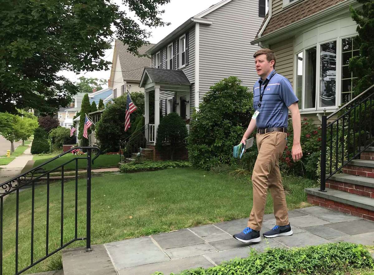 State Rep. Sean Scanlon, executive director of the Tweed New Haven Airport authority, has spent many hours knocking on doors to reach neighbors of the airport as Tweed seeks to expand. He's shown on Stuyvesant Avenue in New Haven.