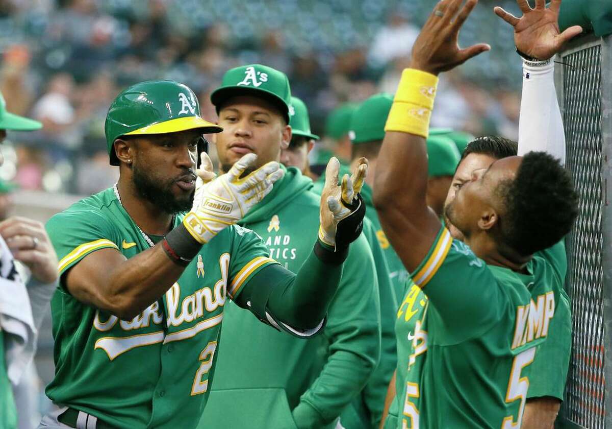 Oakland Athletics' Starling Marte (2) celebrates with Tony Kemp (5) after hitting a solo home run against the Detroit Tigers during the fourth inning of a baseball game Wednesday, Sept. 1, 2021, in Detroit. (AP Photo/Duane Burleson)
