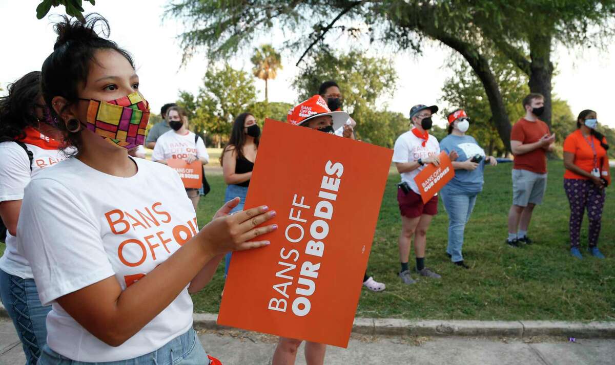 Miranda Garza, left, joins other women who gathered to participate in a statewide protest against Texas’ new anti-abortion law on Wednesday at San Pedro Springs Park.