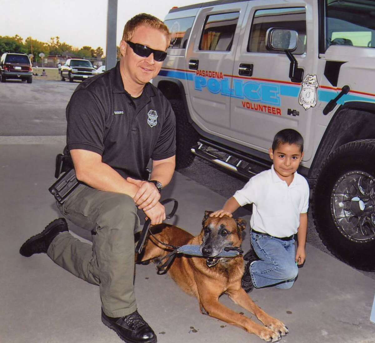 National Night Out is a long-standing annual tradition for law enforcement and communities to get together and build partnerships. A boy gets acquainted with a Pasadena police officer and his dog at a previous event. 