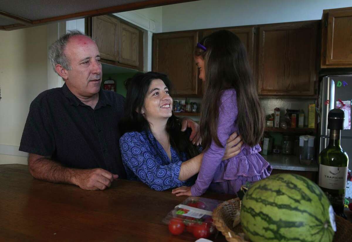 Dale Duncan and his wife Marta Munoz, photographed in 2015, play with their daughter Emilia at their Mission District apartment in San Francisco. The couple was awarded a $2.7 million judgment against a San Francisco landlord accused of terrorizing them in an effort to oust them in favor of higher-paying tenants.