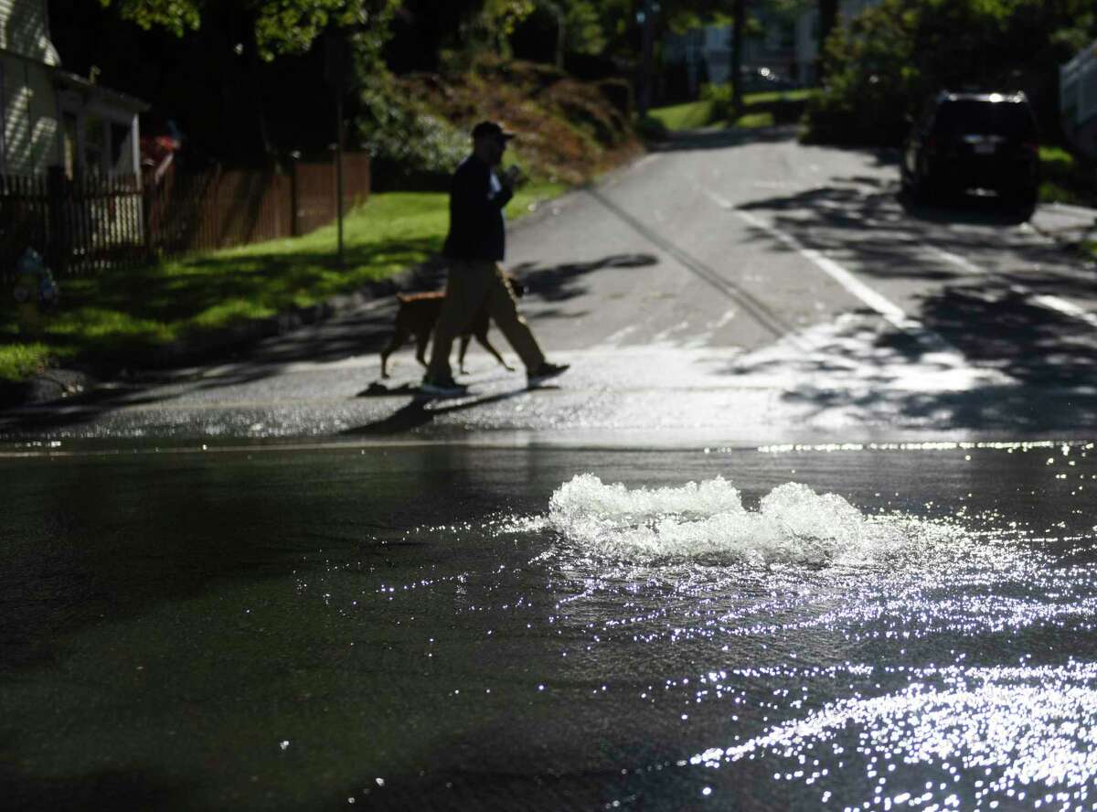 A storm drain spews water on to South Water Street in Byram the day after the remnants of Hurricane Ida hit Greenwich, Conn. Thursday, Sept. 2, 2021. More than six inches of rain fell Wednesday into Thursday morning, causing severe flooding and power outages across the region.