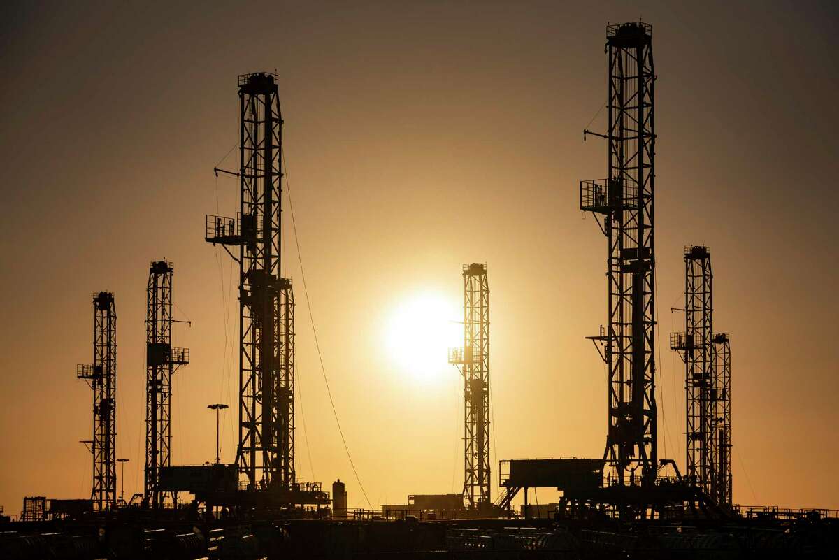 The morning sun rises behind oil rigs sitting in storage Saturday, Feb. 6, 2021 at a yard outside of Odessa, Texas. (Eli Hartman/Odessa American via AP, file)