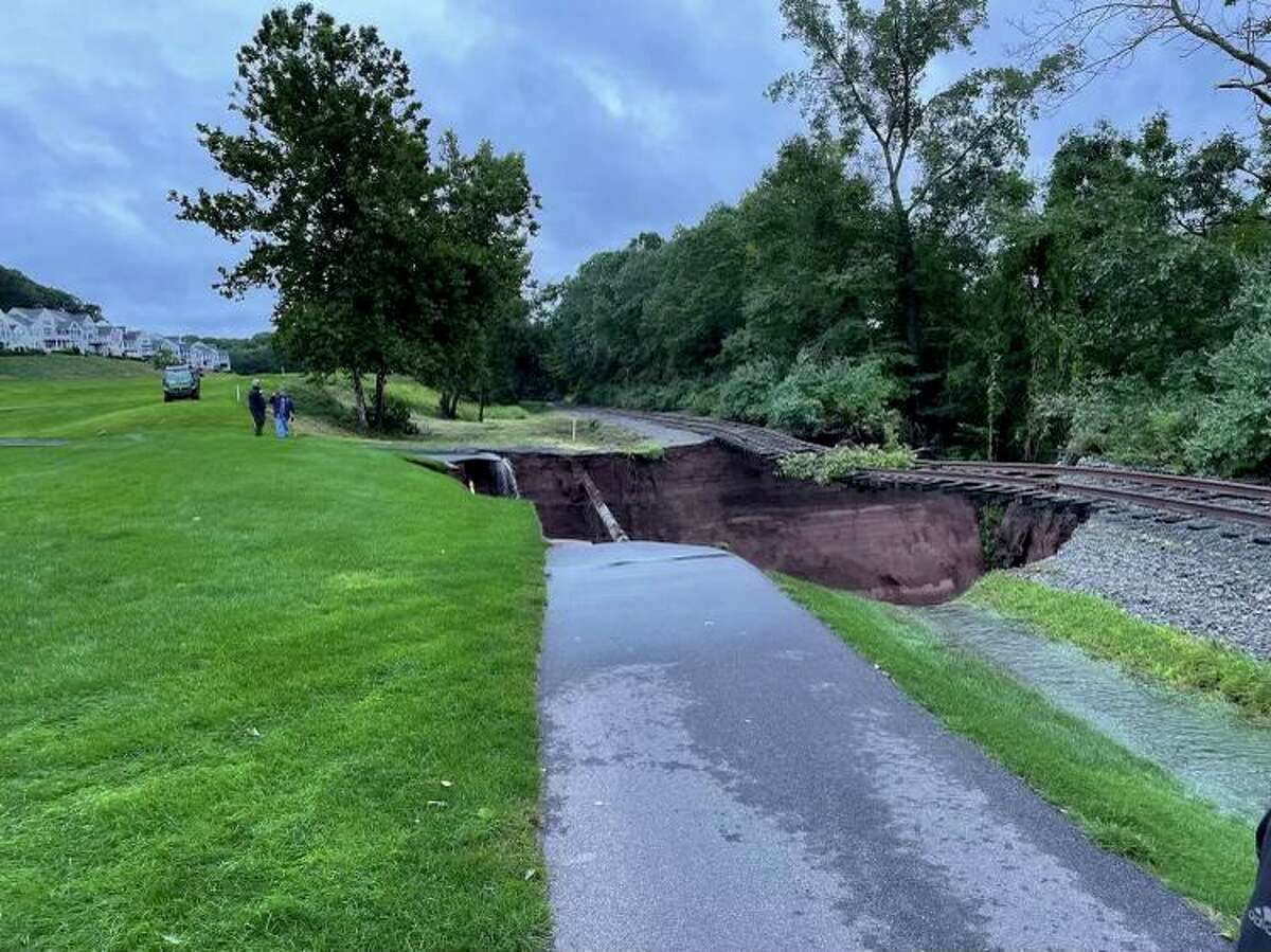 Major rain from Hurricane Ida washed out a cart path at TPC River Highlands in Cromwell and left a gas pipeline and railroad tracks suspended in the air.
