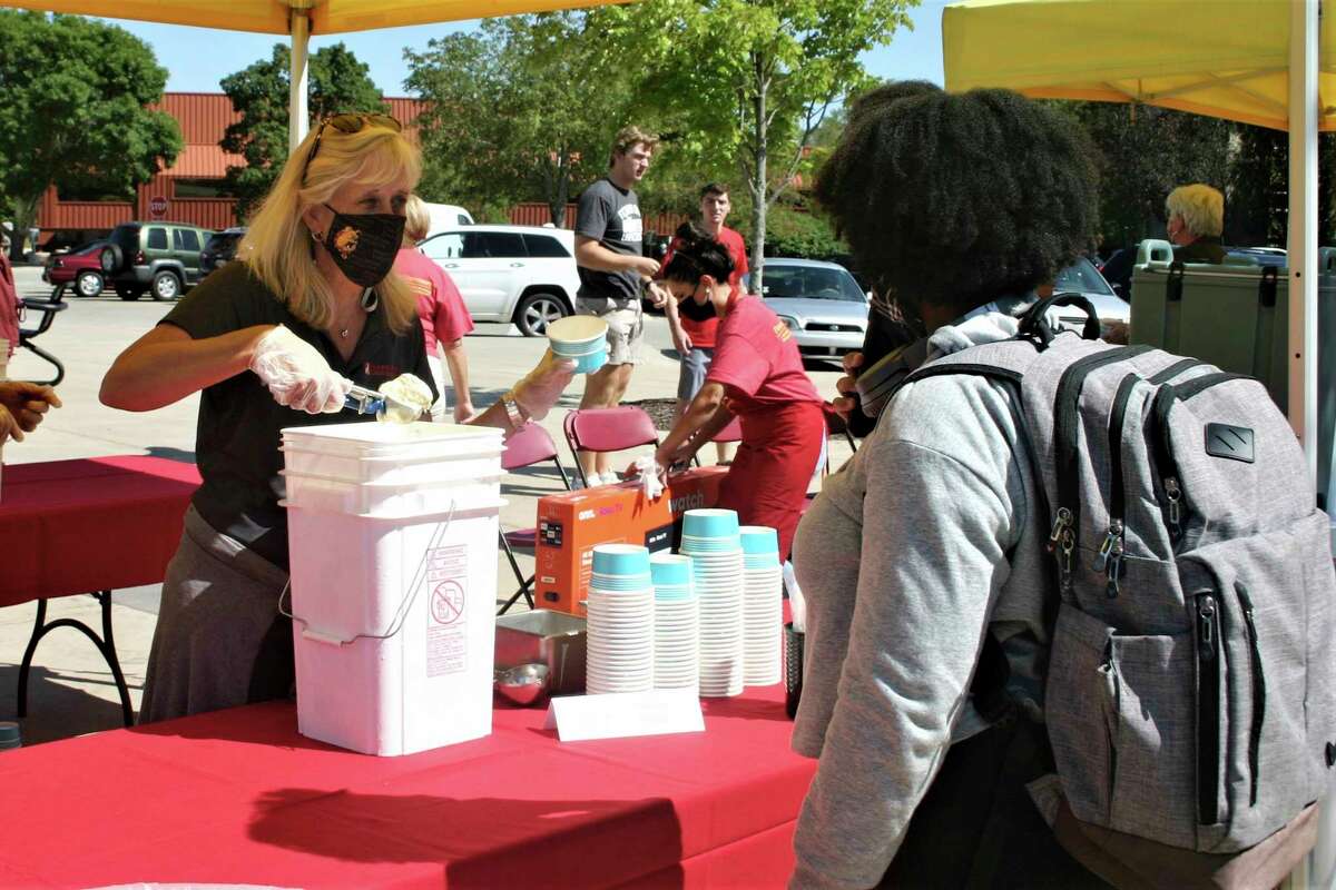 Ferris State University students and staff gathered in Robinson Quad for a resource fair and ice cream social Thursday afternoon. The event was part of the university's annual Founder's Day celebration. (Pioneer photo/Cathie Crew)