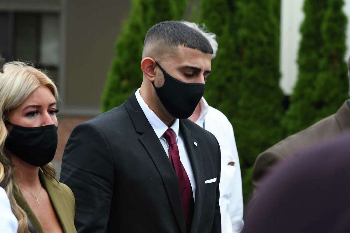 Nauman Hussain, center, operator of the limousine in the deadly 2018 Schoharie limo crash, leaves court after agreeing to plead guilty to 20 counts of criminally negligent homicide in exchange for five years of probation and 1,000 hours of community service that will include public speaking appearances on Thursday, Sept. 2, 2021, at Schoharie Central School in Schoharie, N.Y.