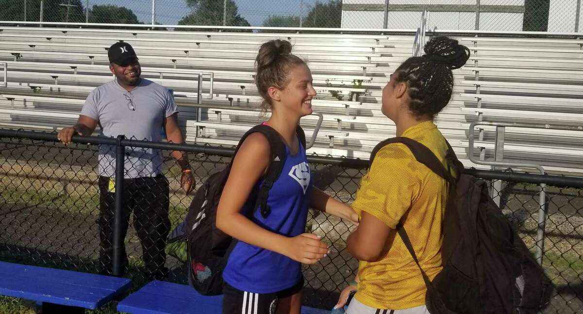 Southington's Jess Carr, left, and Mercy's Melina Ford chat following a preseason scrimmage between the two teams at Southington's Fontana Field on Aug. 31, 2021.