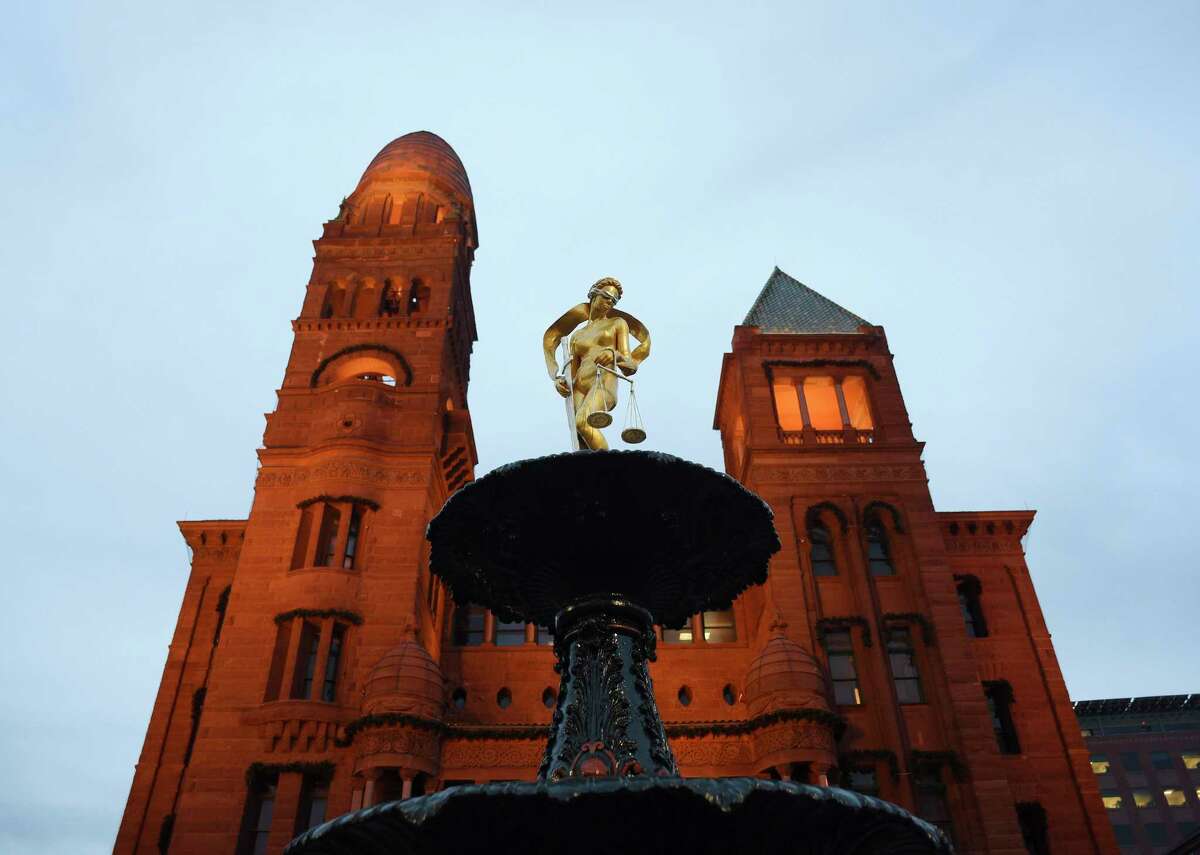 The Lady Justice statue atop a fountain in front of the Bexar County Courthouse gleams after being refurbished by artist Gilbert E. Barrera in 2017.