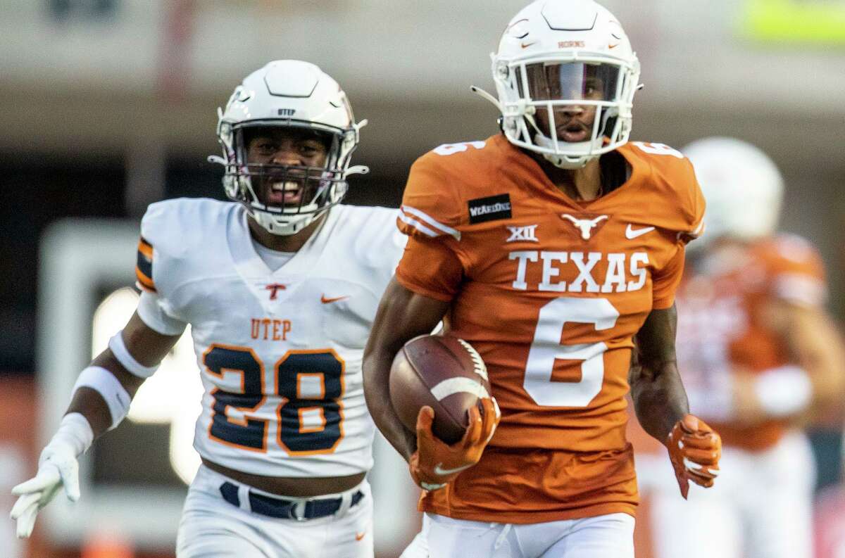 Texas' Joshua Moore (6) runs into the end zone for a touchdown, in front of UTEP defensive back Broderick Harrell (28) during the first quarter of an NCAA college football game Austin, Texas, Saturday, Sept. 12, 2020.