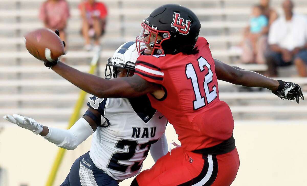 Lamar's Marcellus Johnson reaches to complete the pass against pressure from North American during their season opening home game Thursday. Photo made Thursday, September 2, 2021 Kim Brent/The Enterprise