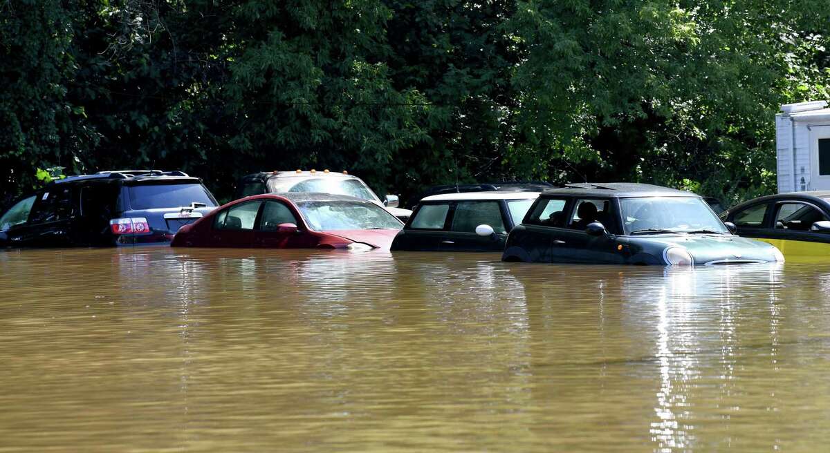 Cars parked in a lot at EZ2Drive Auto Group on Federal Road in Danbury are partially submerged on Sept. 2 after heavy rains from Hurricane Ida drenched the area the day before and into the night.