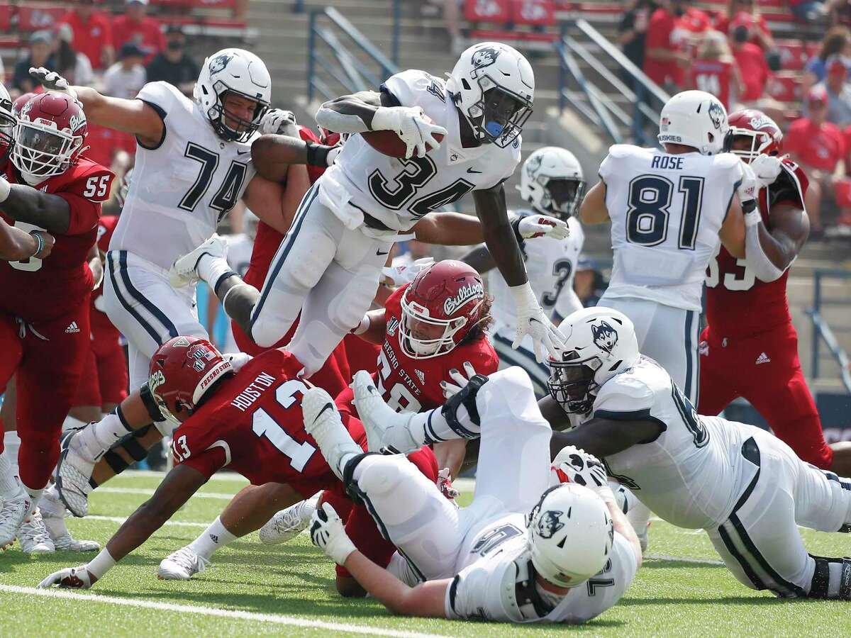 UConn running back Kevin Mensah (34) goes up for a short gain against Fresno State on Saturday.