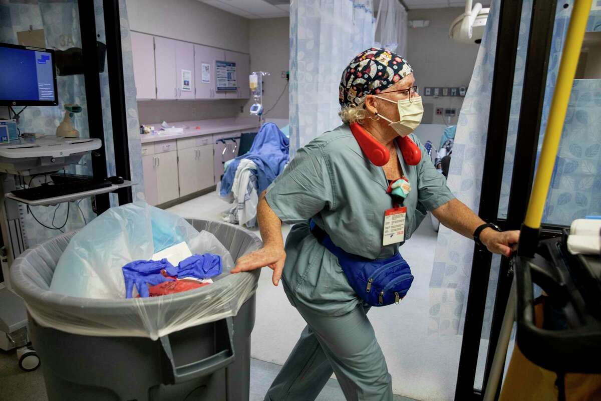 With nurses and doctors so busy with the influx of COVID patients, Winters often ends up changing bedpans and comforting dying patients, on top of her regular cleaning duties.