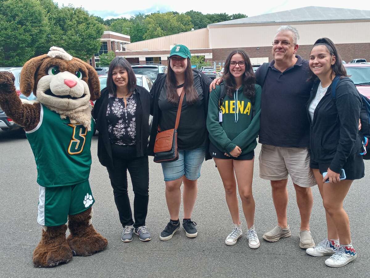(From left to right) Bernie the Siena College mascot, Laurie Filippone (mother), Alyssa Filippone (older sister), Glenn Filippone (father), and twin freshman Alexa (left) and Ava (right) move in at Siena College in Loudonville, N.Y. on Friday, Sept. 3, 2021 after the remnants of Hurricane Ida flooded their Westchester home.