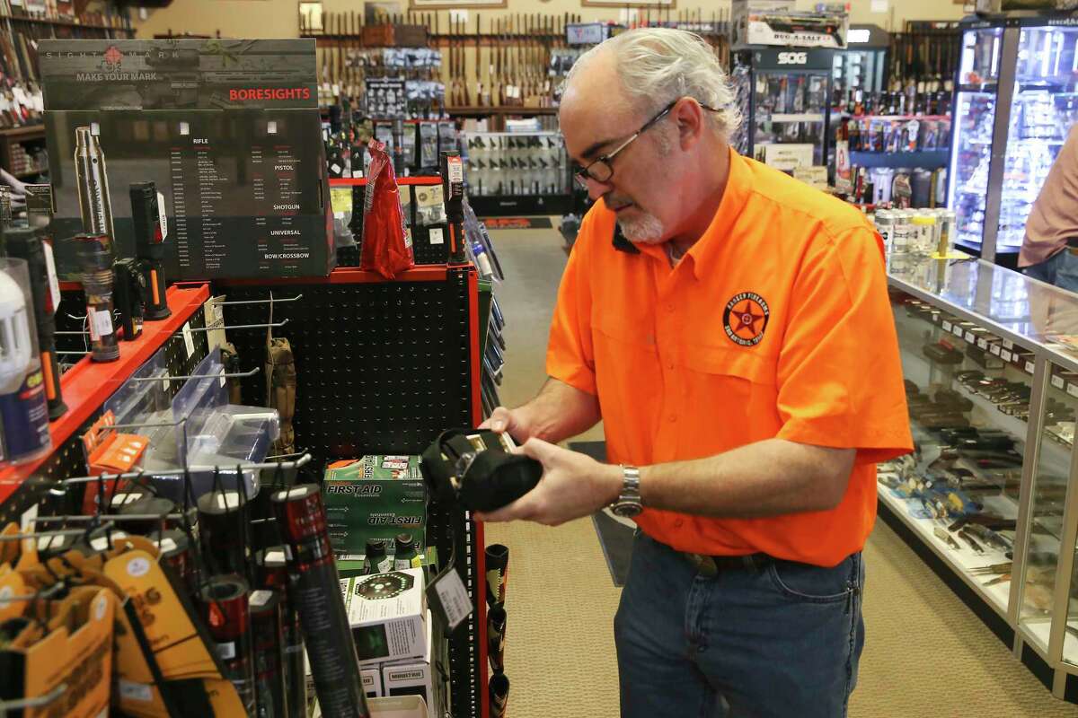Ranger Firearms owner Edward E. DeWees III takes a call Friday, Aug. 3, 2021. Texas' "constitutional carry" law takes effect this week, allowing adults over 21 without criminal backgrounds to carry handguns without a license.