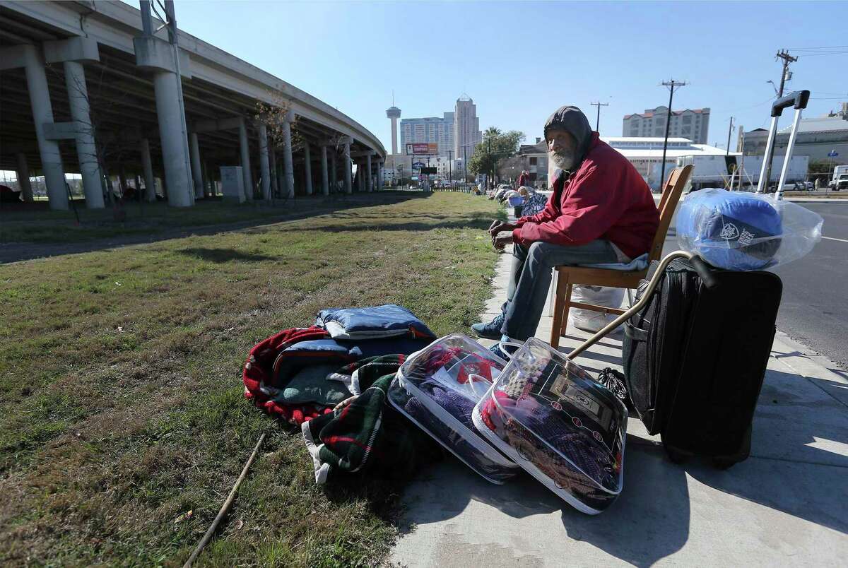 A homeless man sits beside his belongings after a camp beneath U.S. 281 was cleared in February. A reader expresses concern for the homeless but also sees a need for police presence downtown to maintain order.