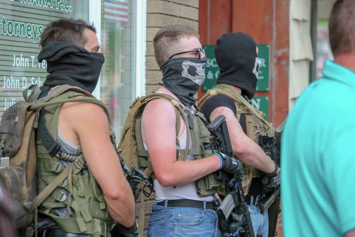 Tensions mount as Thomas Denton, Tristan Webb and Justen Watkins stand by with firearms during a social injustice rally Friday, June 5, 2020.