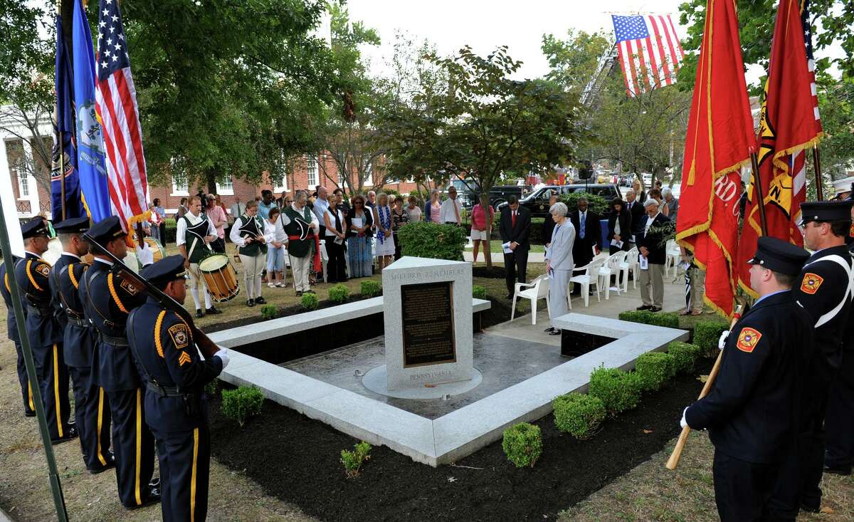 Milford, which lost three residents in the 9/11 attacks, marks the 13th anniversary of the day at a memorial service behind Milford City Hall in downtown Milford, Conn., on Thursday Sept. 11, 2014.