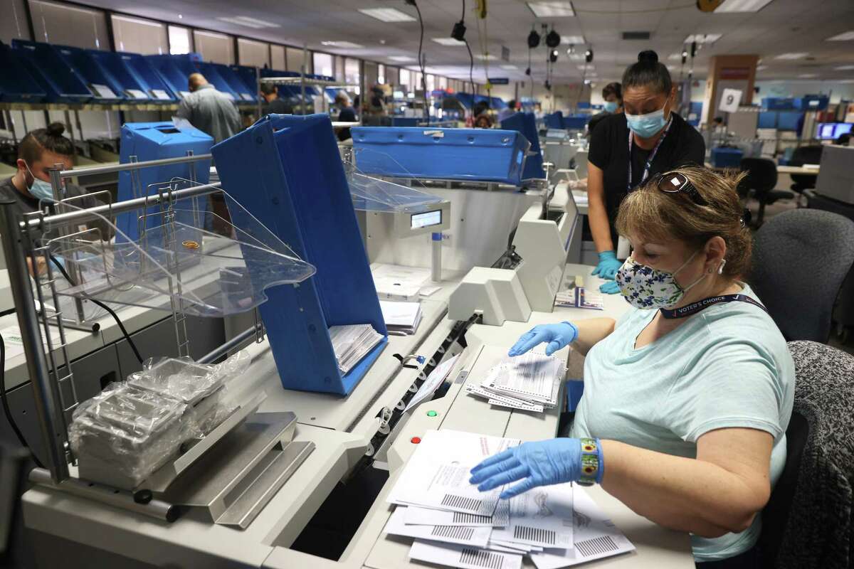 Workers sort through mail-in-ballots at the Santa Clara County Registrar of Voters in San Jose last month.