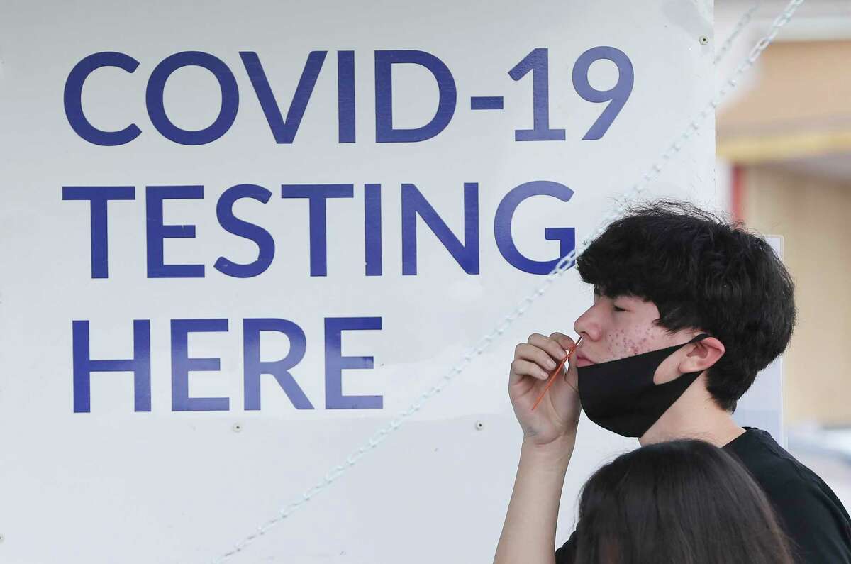 Fabian Cedillo, 16, performs a self-swab to be tested for COVID-19 at the Curative mobile testing site at the American Legion Alamo Post #2 on Fredericksburg Road on Friday, Sept. 3, 2021.