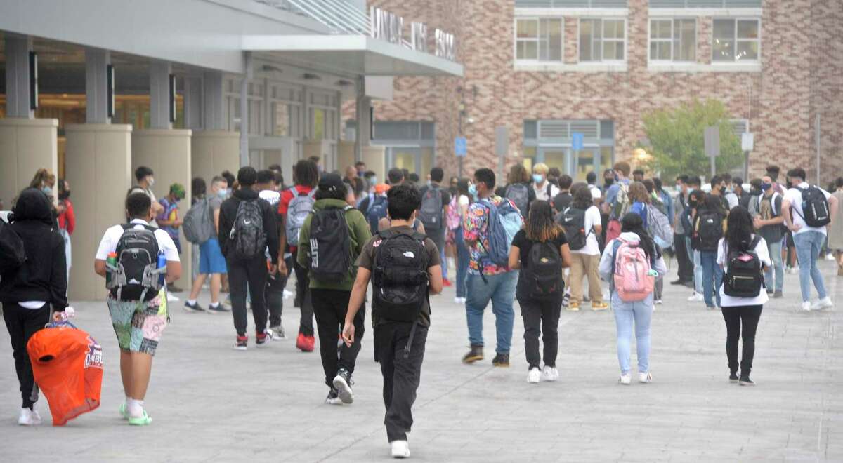 Students head into Danbury High School on the first day of the new school year. Monday, August 30, 2021, Danbury, Conn. Fourteen science labs at the high school are planned to be upgraded.