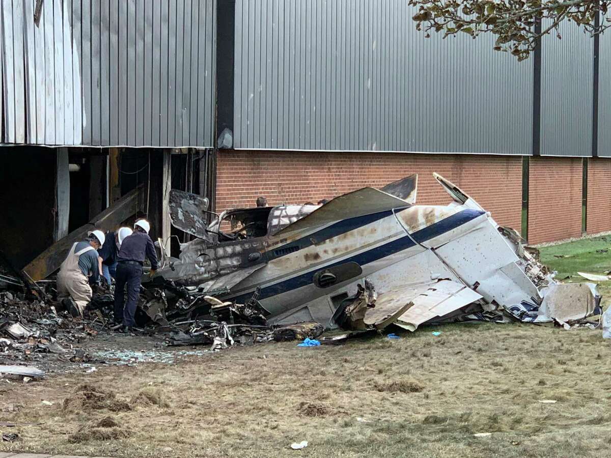 Investigators look through the wreckage of a plane crash at the Trumpf building in Farmington, Connecticut, in 2021.