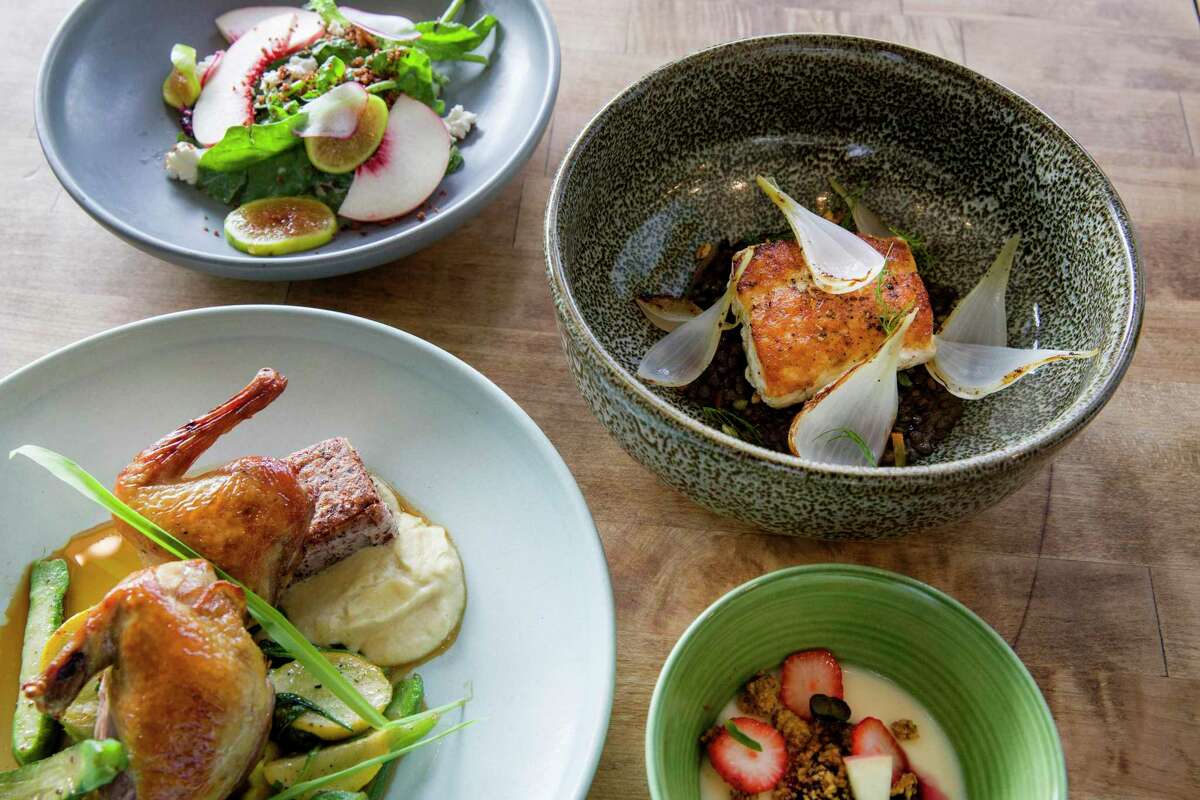 A four-course meal from Cassava consisting of spinach and stone fruit salad; halibut; roasted squab; and a honey lavender panna cotta in 2017. The restaurant is bringing its prix-fixe dinners, now three courses, to North Beach.