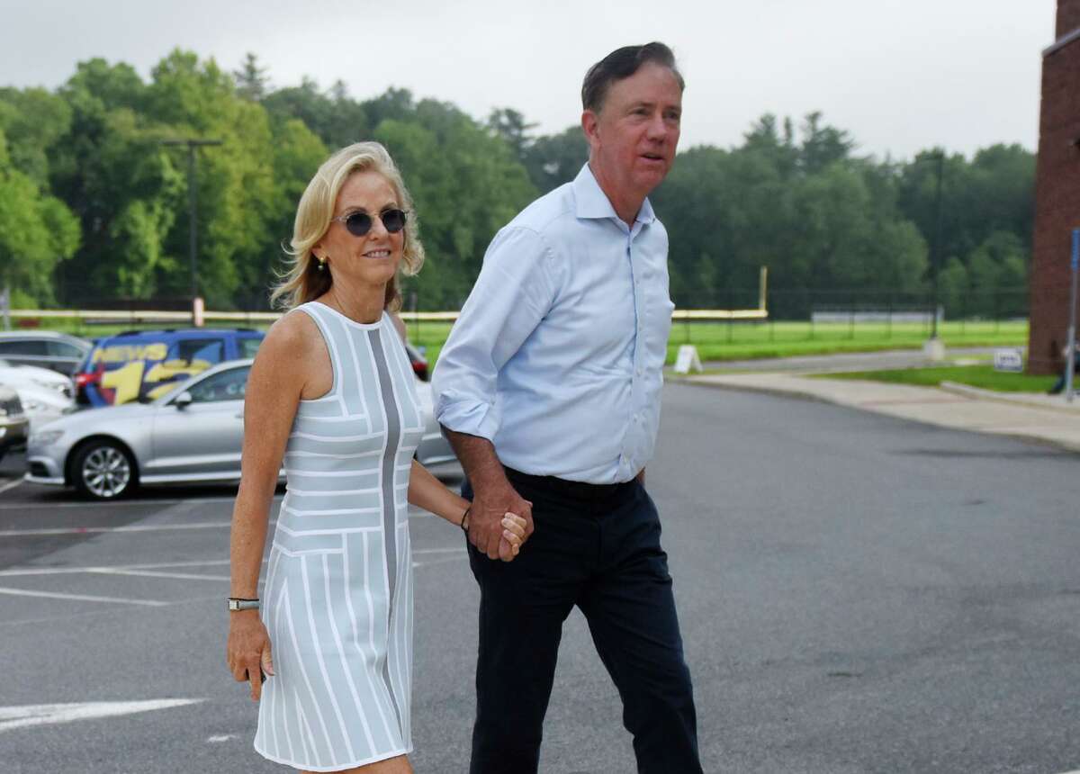 Then-candidate Ned Lamont and his wife, Annie, enter the Greenwich District 7 polling center to vote in the primary election at Greenwich High School in Greenwich, Conn. Tuesday, Aug. 14, 2018. The two live in town and were spotted dining together.