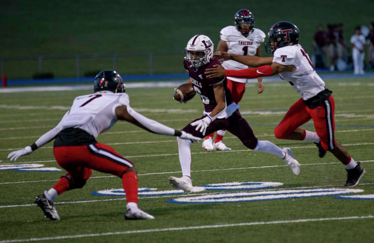 Legacy’s Michael Valles (6) tries to evade Tascosa’s Brenyn Barnes (7) and Andon Scroggins on Friday, Sept. 3, 2021 at Grande Communications Stadium. Jacy Lewis/Reporter-Telegram