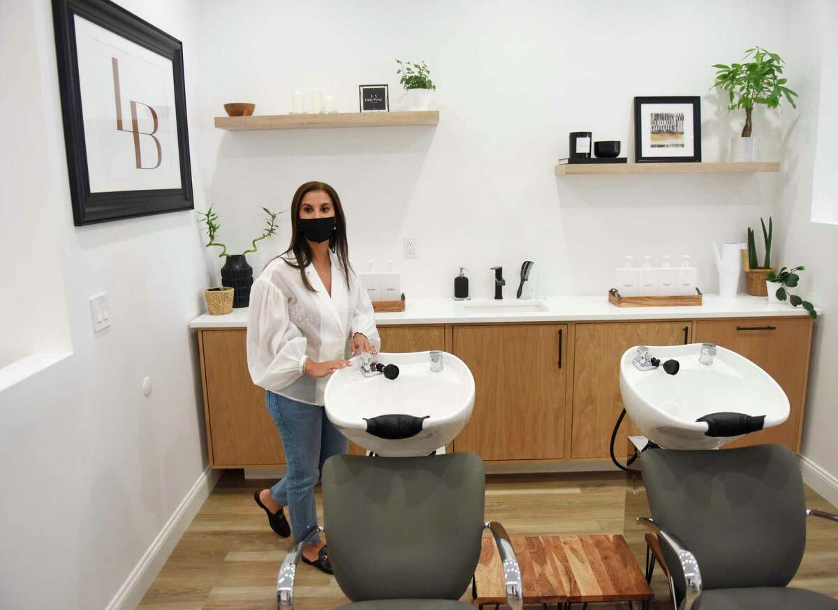 Owner Stephanie Leone-Kim shows the hair washing stations at La Brosse Dry Bar in the Cos Cob section of Greenwich, Conn. Tuesday, Aug. 31, 2021. The salon located in Mill Pond Shopping Center opened over the summer and offers blow dry services, keratin treatment, and bridal hair styling.
