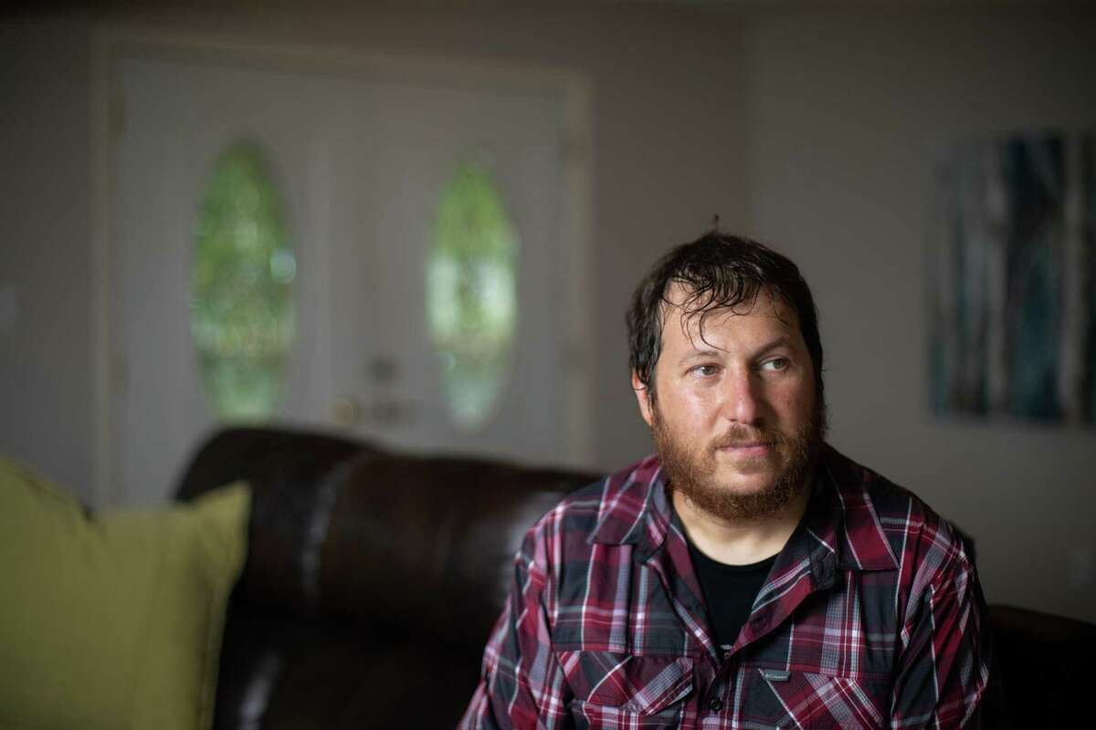 Josh Dzik works as a driver in Houston's gig economy, working 70-hour weeks, sometimes more, to cover child support for two kids and save for a house, which he closed on last month. He makes good money, but working 10-plus hour days seven days a week has taken its toll during the pandemic, when he's already caught COVID-19 once and fears another round. Dzik stands on the new home, Friday, Sept. 3, 2021, in Santa Fe.