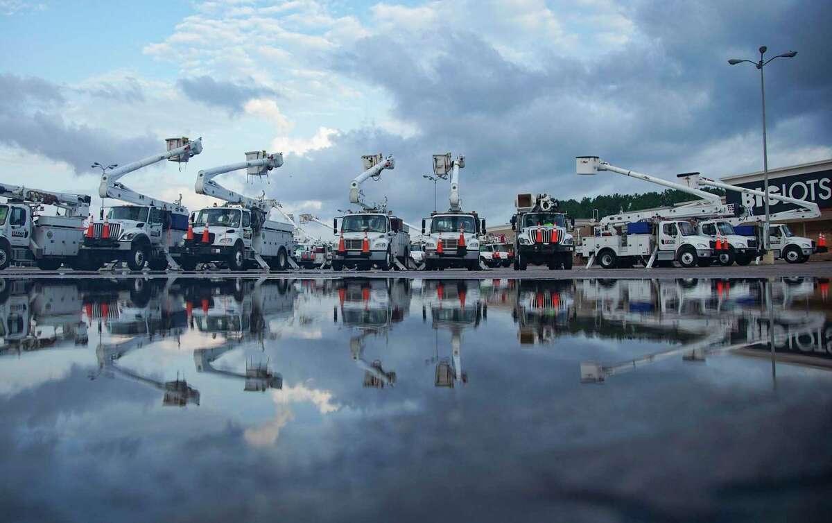 Utility trucks gather in Orange, Texas as recovery efforts continue following Hurricane Laura on Friday, Aug. 28, 2020.