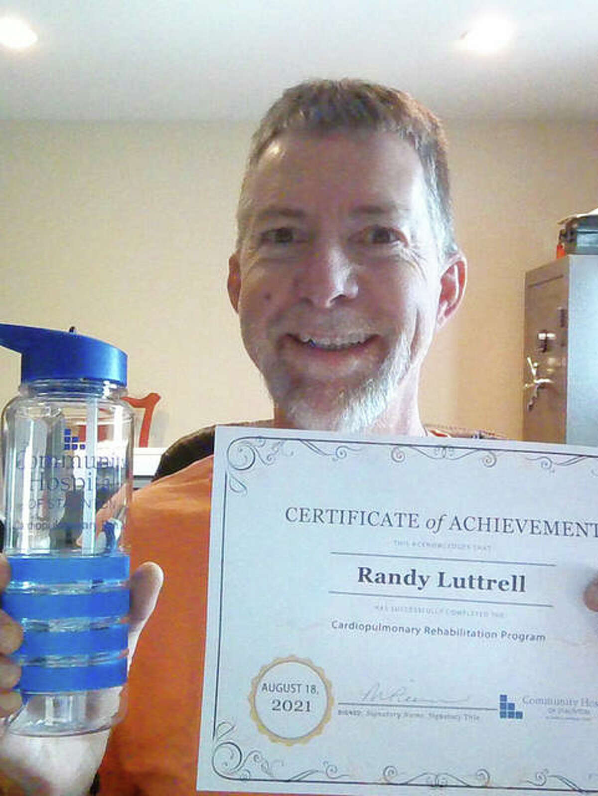 Former Edwardsville Police Officer Randy Luttrell with his cardio rehab certificate of achievement. Luttrell, whose life was saved by an auto CPR compression machine when he suffered a heart attack in March, is part of a GoFundMe drive to purchase a machine for the Prairietown Fire Department.