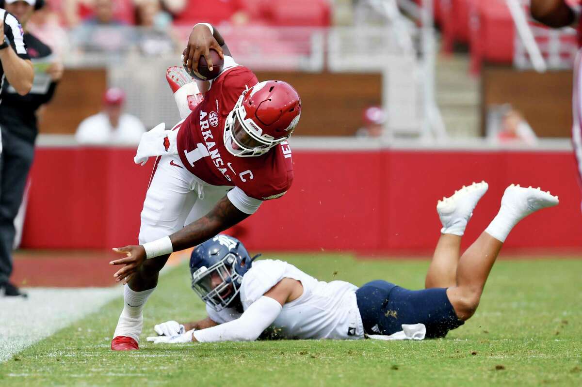 Arkansas quarterback KJ Jefferson (1) is tripped up by Rice defender Cameron Montgomery (1) as he runs the ball during the first half of an NCAA college football game, Saturday, Sept. 4, 2021, in Fayetteville, Ark. (AP Photo/Michael Woods)