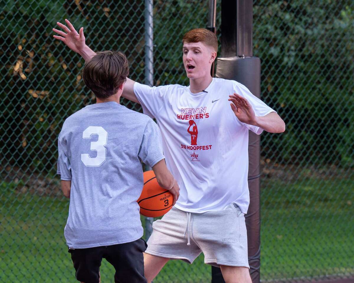 Kevin Huerter, (left) a former basketball star at Shenendehowa and current Atlanta Hawks player, instructs a participant at the Kevin Huerter’s 518 Hoopfest at the Clifton Common basketball courts in Clifton Park, NY, on Saturday, Sept. 4, 2021. (Jim Franco/Special to the Times Union)