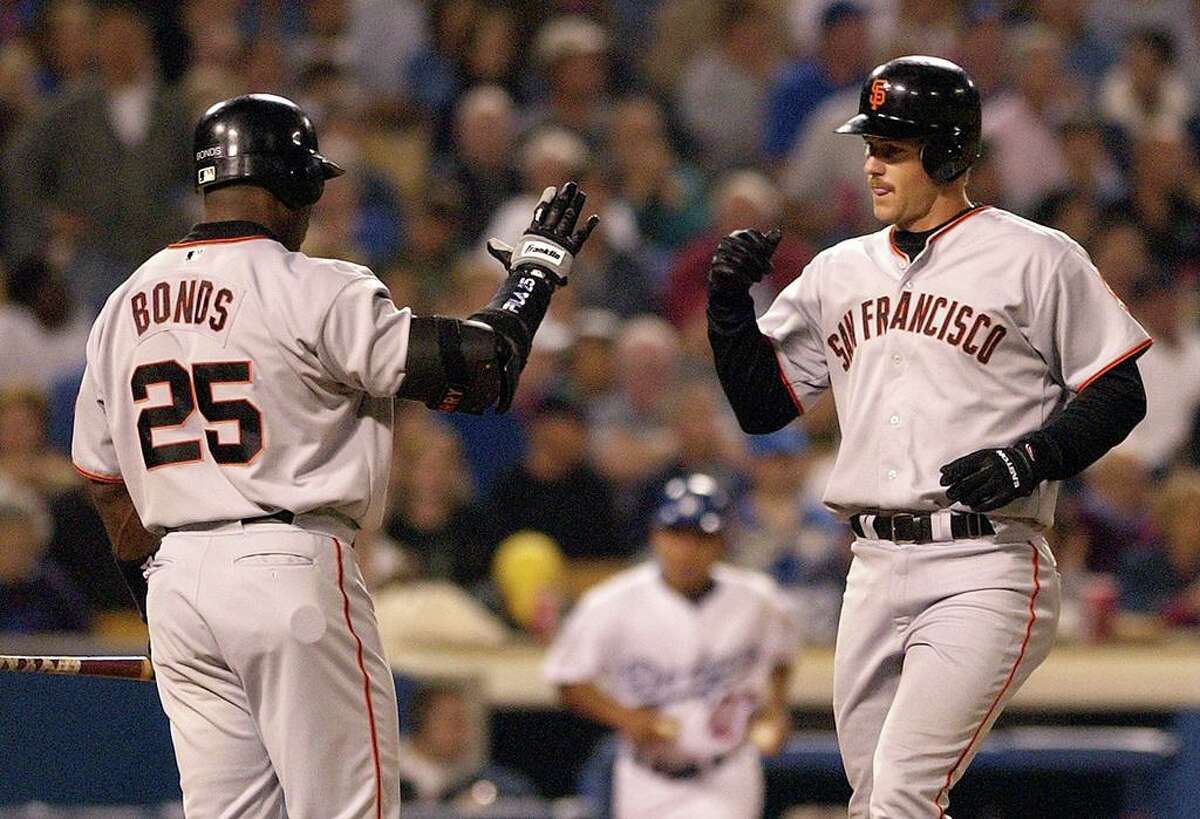 San Francisco Giants' Jeff Kent, right, is congratulated by teammate Barry Bonds after hitting a home run in the third inning against the Los Angeles Dodgers, Wednesday night, Sept. 18, 2002, in Los Angeles. (AP Photo/Mark J. Terrill)
