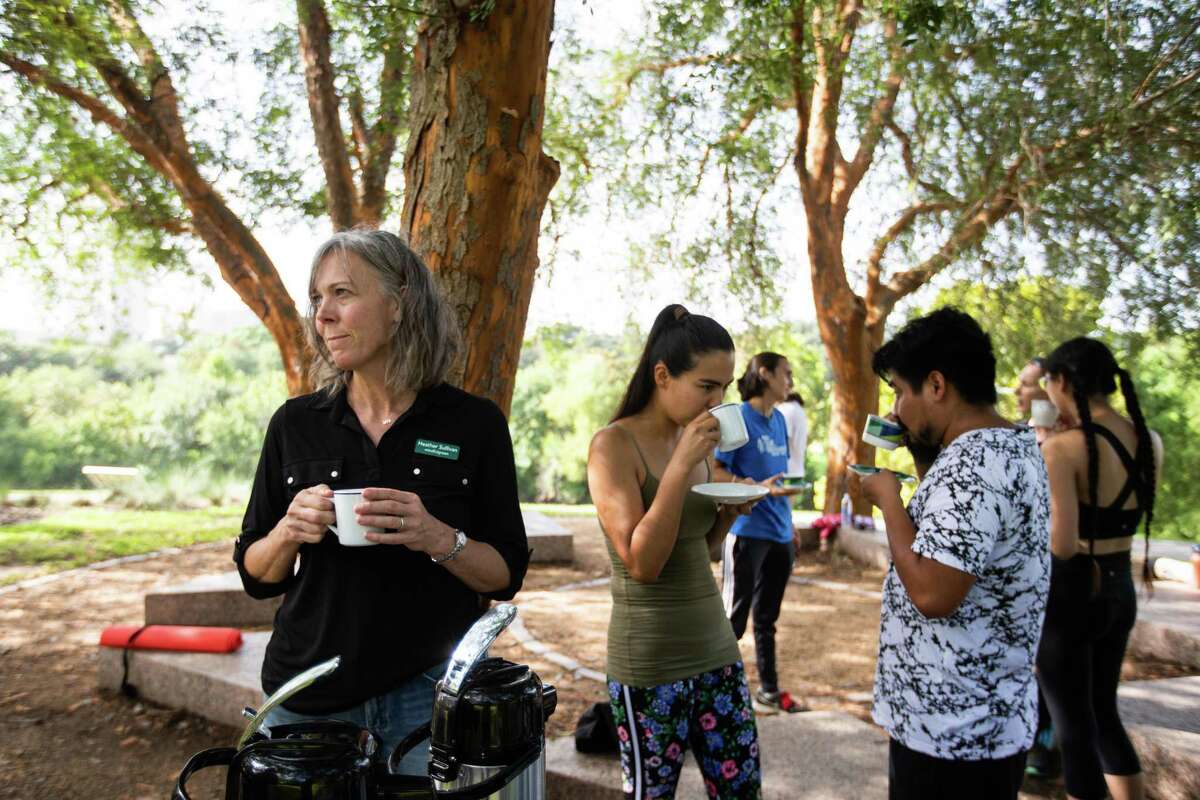 Heather Sullivan, a mindfulness instructor drinks tea after teaching a meditation and mindfulness class as part of Grounding with the Trees at Buffalo Bayou Park, Saturday, Sept. 4, 2021, in Houston. The practice is inspired by Forest Bathing movements in South Korea and Japan.