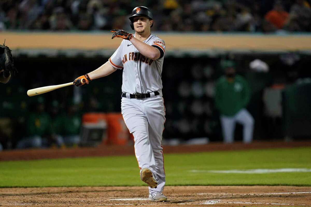 San Francisco Giants' Alex Dickerson reacts after striking out against the Oakland Athletics during the seventh inning of a baseball game in Oakland, Calif., Friday, Aug. 20, 2021. (AP Photo/Jeff Chiu)