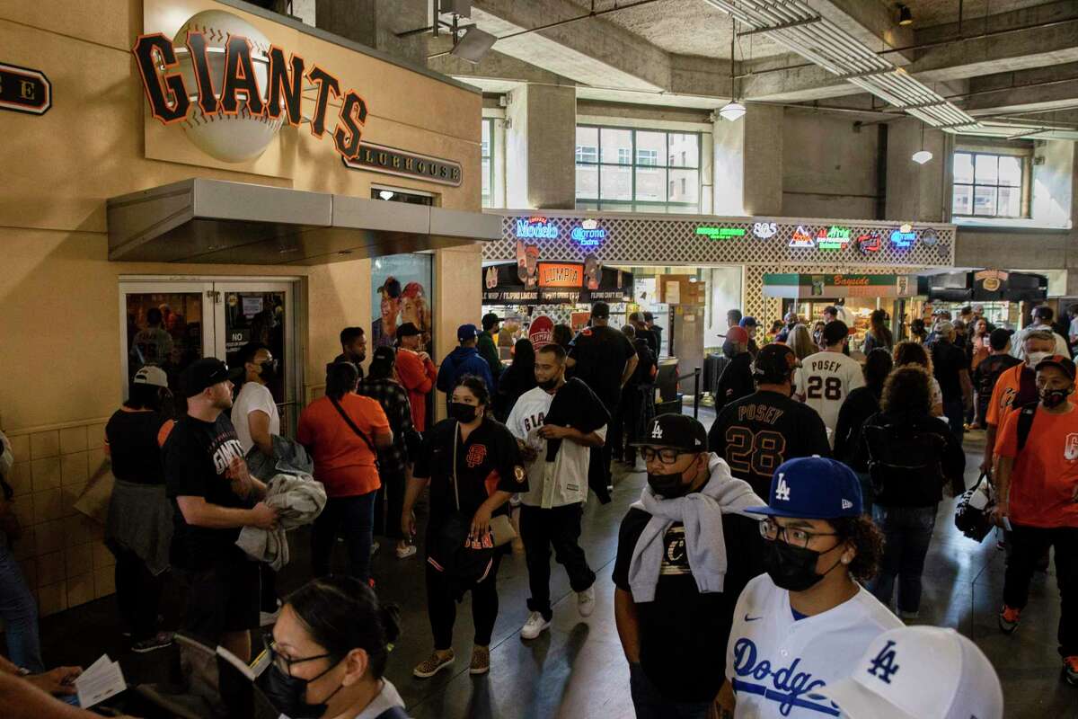 Fans visit vendors as Unite Here Local 2, a union representing about 930 concessions workers at Oracle Park held a strike vote shortly before a baseball game between the San Francisco Giants and the Los Angeles Dodgers in San Francisco, Saturday, Sept. 4, 2021. (AP Photo/John Hefti)